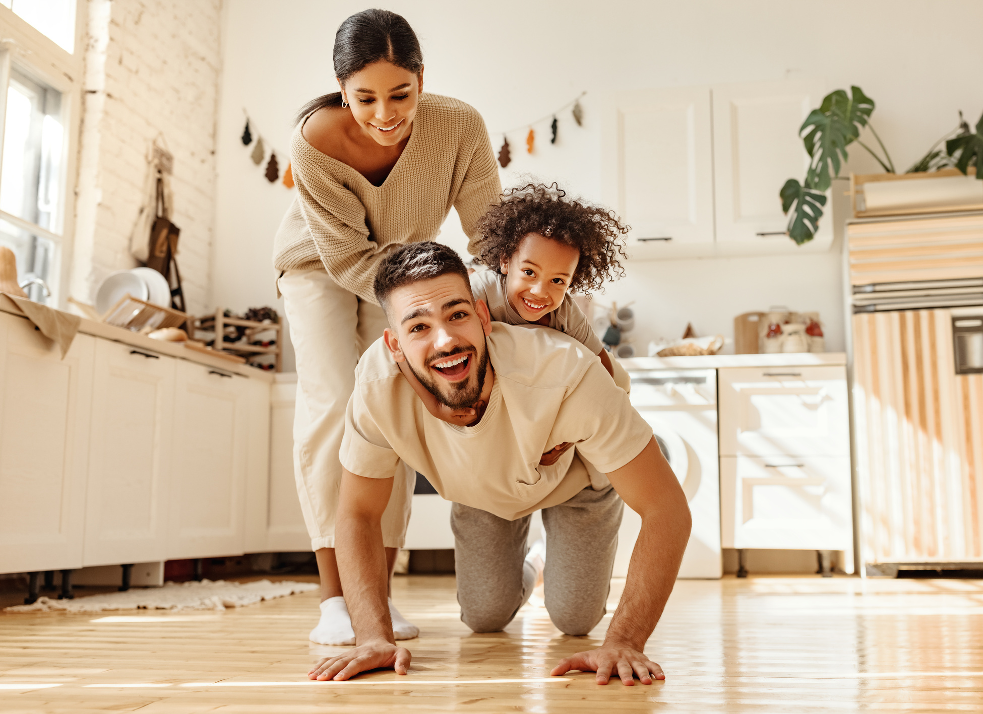 Happy multiracial family playing in kitchen